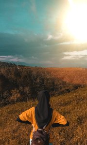 Woman Wearing Black Headdress On Top Of Mountain