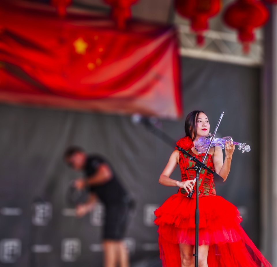 Woman Playing Electric Flying On Stage