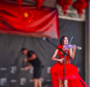 Woman Playing Electric Flying On Stage