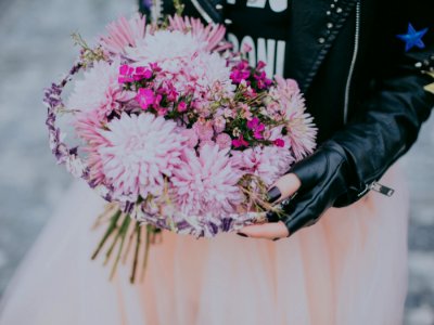 Person In Black Leather Jacket Pink And Red Flower Bouquet photo