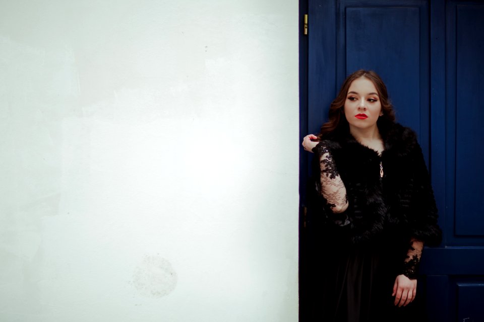 Woman Leaning On Blue Door