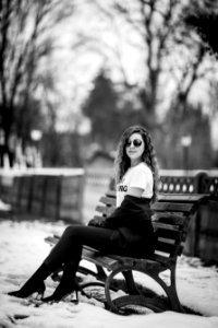 Grayscale Photography Of Woman Sitting On Bench photo