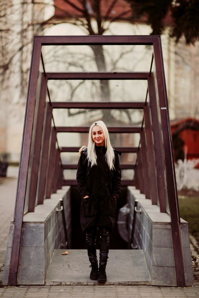 Woman In Black Coat Standing Near Staircase