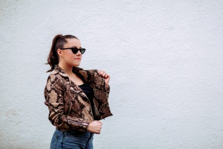 Photo Of Woman Wearing Brown-and-black Snakeskin Jacket Beside Wall