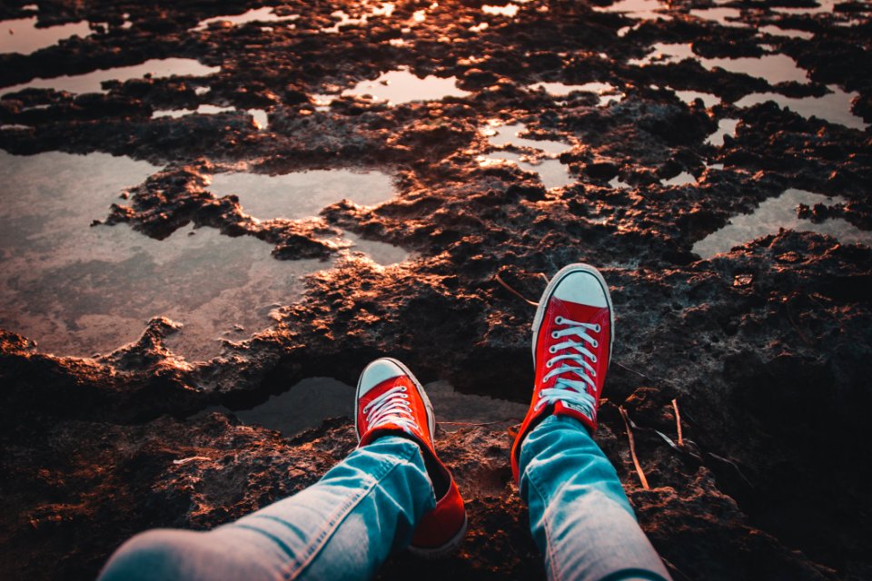 Person Wearing Red Low-top Sneakers And Jeans