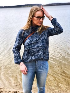 Woman In Blue And Gray Long-sleeved Shirt And Blue Denim Jeans Near Body Of Water photo