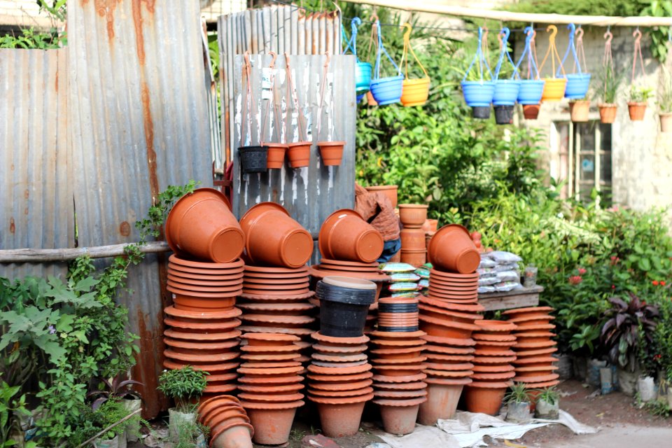 Stack Of Clay Pots Beside Tin Roof