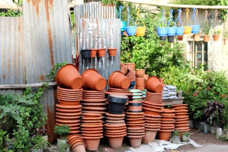 Stack Of Clay Pots Beside Tin Roof