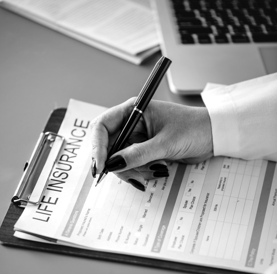 Grayscale Photo Of Person Holding Pen