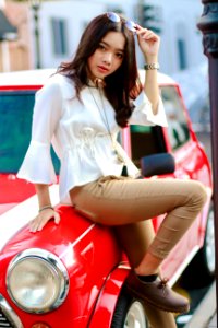 Photography Of A Woman Leaning On The Car photo