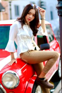 Photography Of A Woman Leaning On The Car