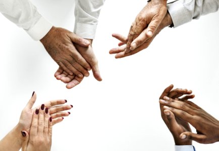 Four People Showing Clap Hand Gestures photo