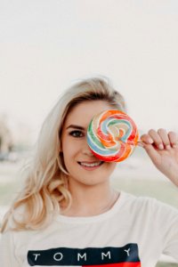 Close-Up Photography Of A Woman Holding Lollipop photo