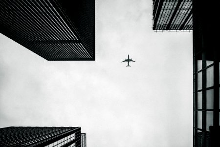 Low Angle Photography Of Airplane And Buildings photo