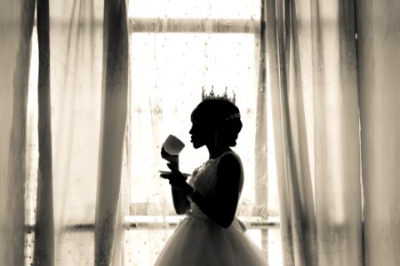 Woman In White Wedding Gown Holding Cup photo