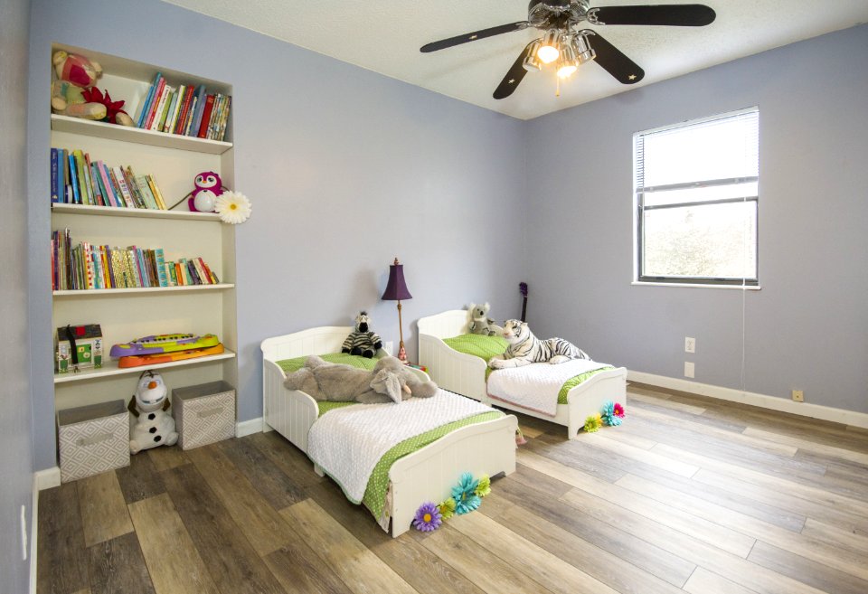 Two Single Beds Beside Books Shelf Inside Room