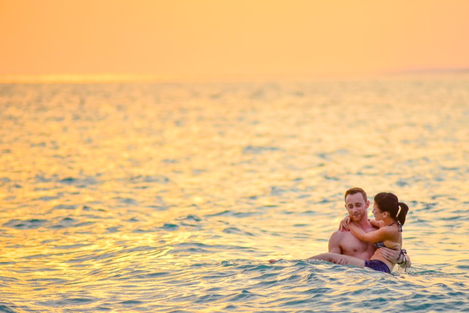 Man And Woman Swimming In A Beach