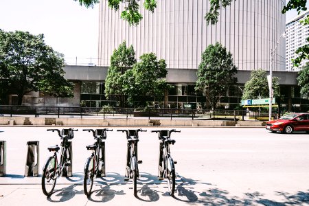 Four Black Parked Bicycles Near The Road photo