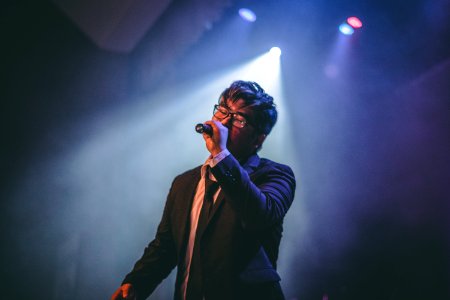 Man Holding Microphone On Stage photo