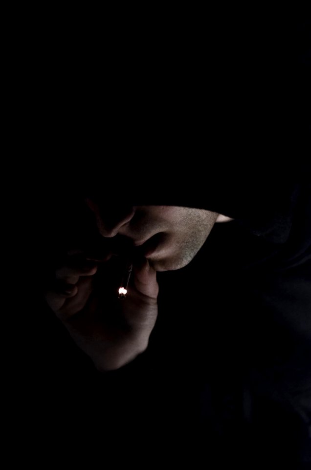 Man In Hoodie Smoking Cigarette