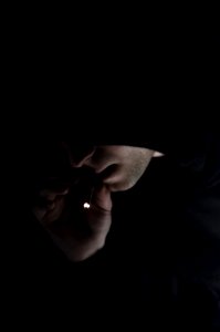 Man In Hoodie Smoking Cigarette photo