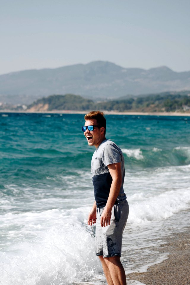 Photography Of A Man Standing On Seashore