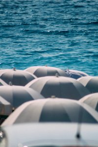 Photography Of Umbrellas Near Ocean