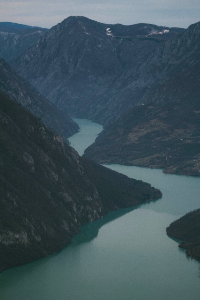 Photography Of A River Between Mountains