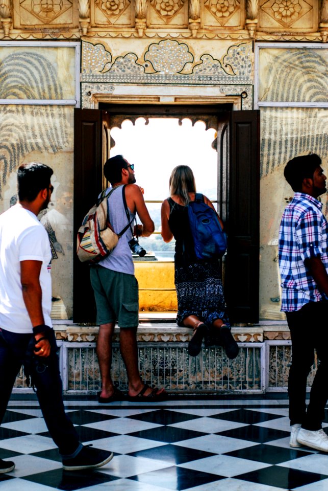 Photo Of Man And Woman Looking At The Window