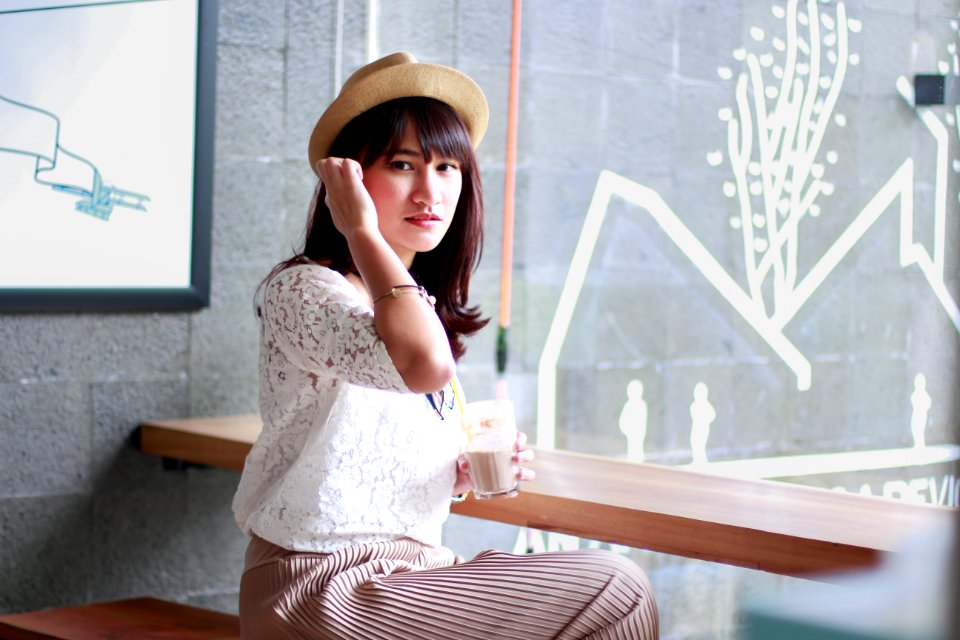 Photography Of A Woman Sitting On Bench photo