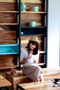 Photo Of Woman Sitting On Wooden Chair photo