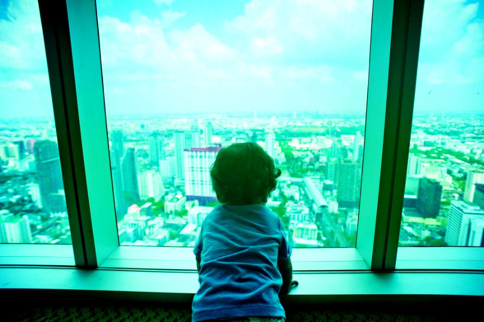 Toddler Looking Through Clear Glass Window