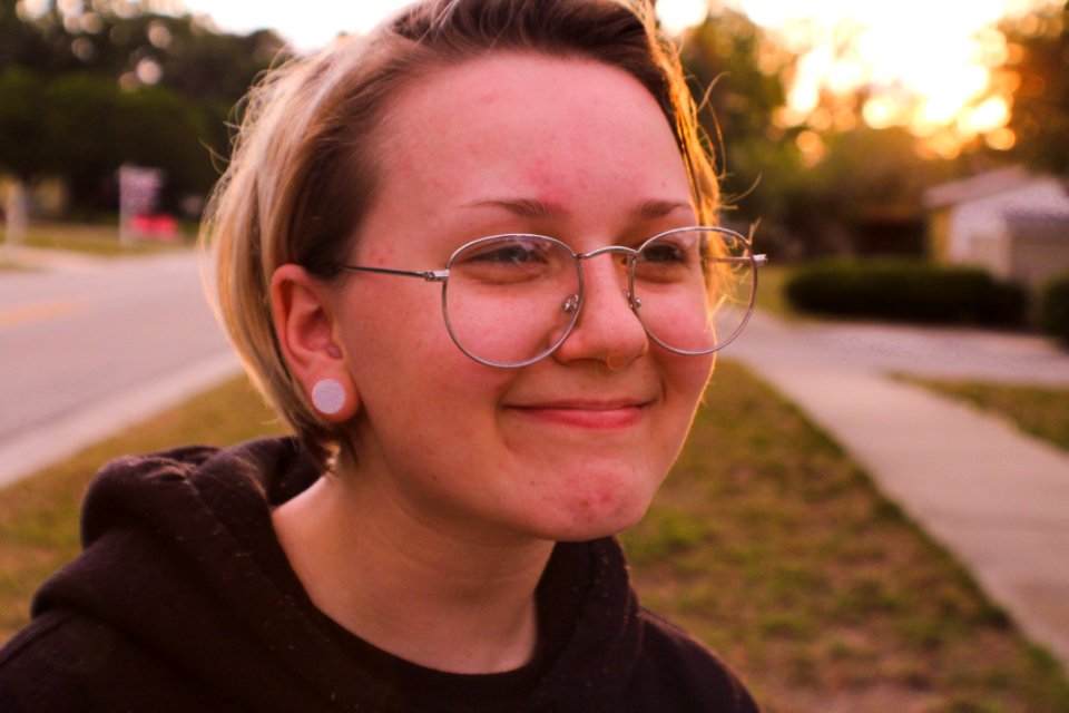Woman Wearing Black Pullover Hoodie And Round Silver-colored Eyeglasses Smiling