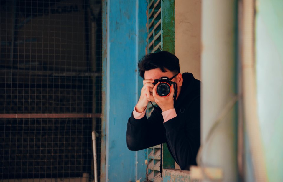 Person Holding Black Dslr Camera