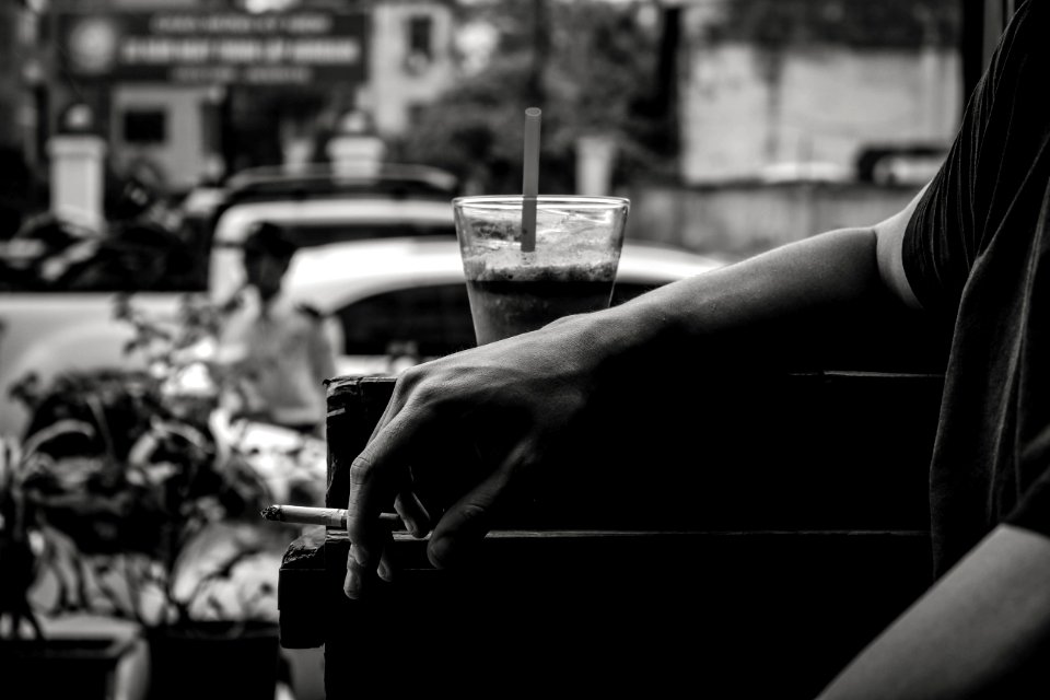 Grayscale Photo Of Person Resting His Arm photo