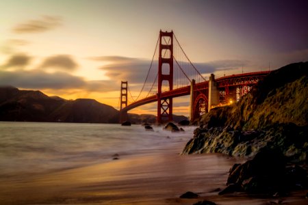 Photography Of Red Bridge Under White And Gray Sky photo