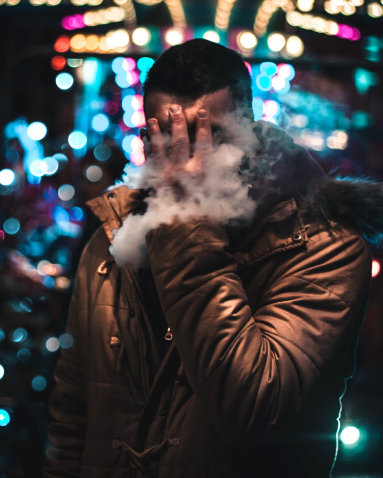 Person Wearing Jacket Holding Face
