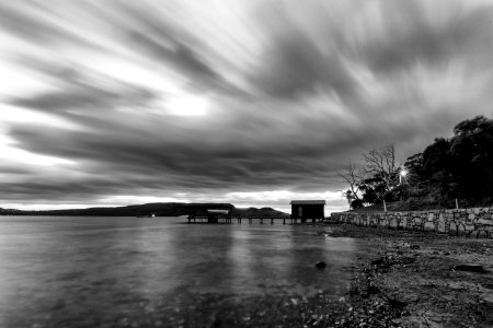 Time Lapse Photo Of A House Near Body Of Water In Grayscale photo