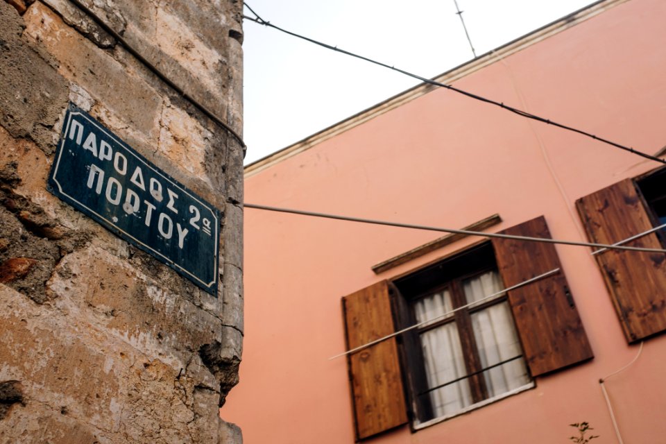 Low Angle Photo Of Alley With Signage On Brick Wall