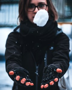 Woman Wearing Black Jacket Holding White Snow photo