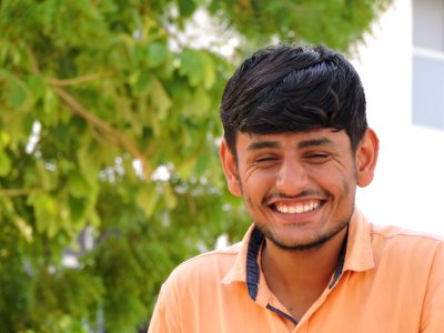 Man Smiles While Taking Photo Near Tall Tree At Daytime photo