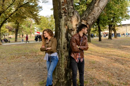 Man And Woman Wearing Leather Jackets Standing Under Tree photo