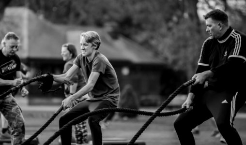 Grayscale Photography Of Two Men Using Exercise Ropes photo