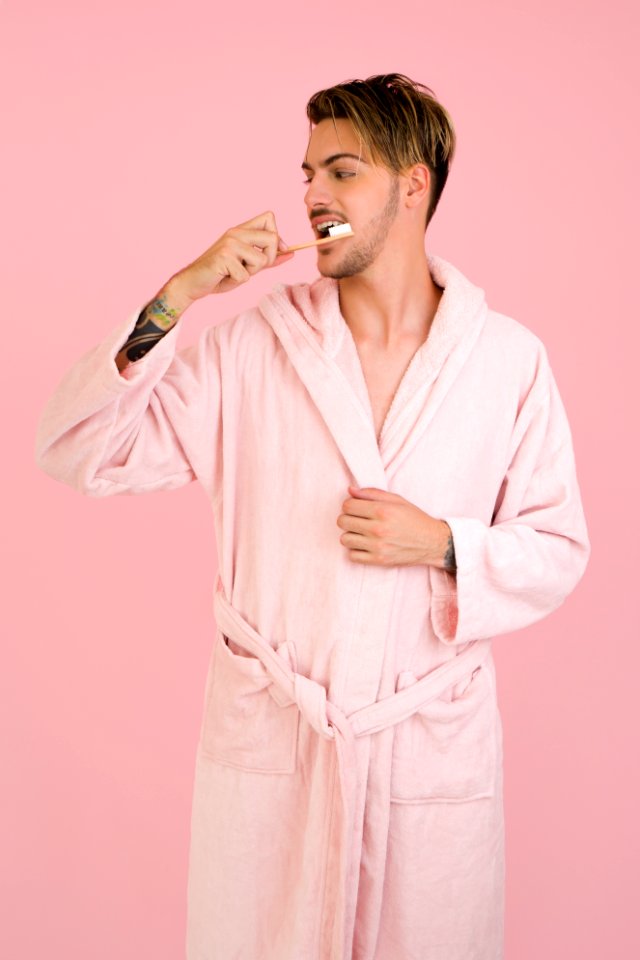 Man Wearing Bathrobe Brushing His Teeth