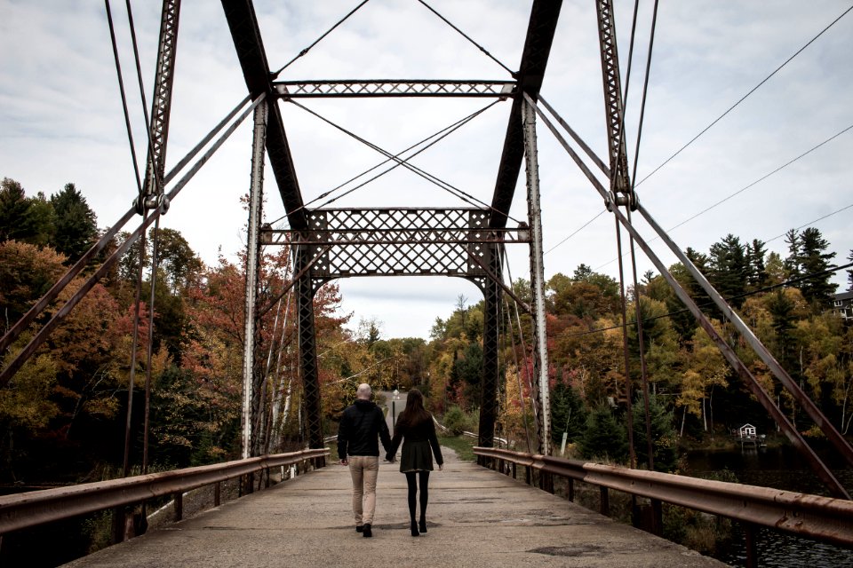 Couple Walking On Gray Bridge At Daytime
