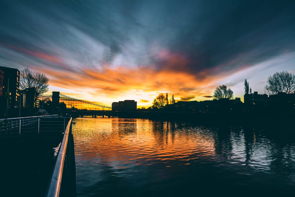 High Rise Buildings Near Body Of Water During Golden Hour
