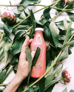 Person Holding Red Glass Bottle photo