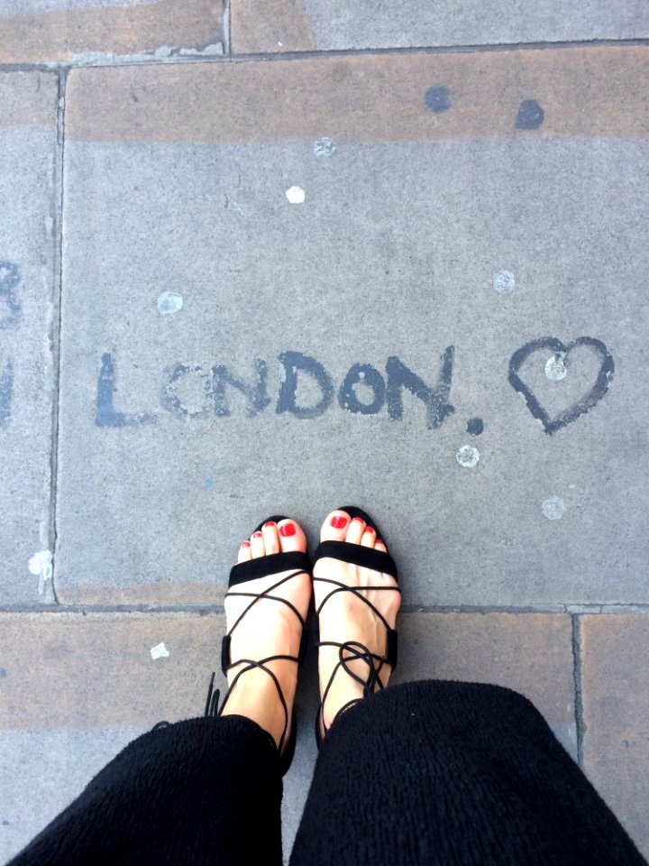 Photo Of Woman Wearing Black Sandals photo