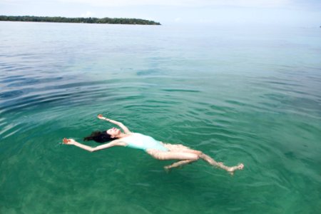 Photography Of A Woman Floating On Water photo
