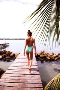 Photography Of A Woman Walking On The Dock photo